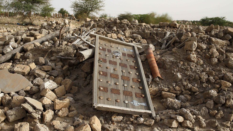 A door from a mausoleum lies on a pile of rubble in Timbuktu