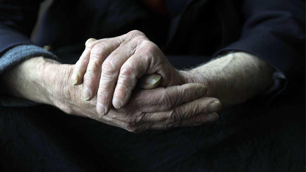 Dementia sufferer rubs hands together