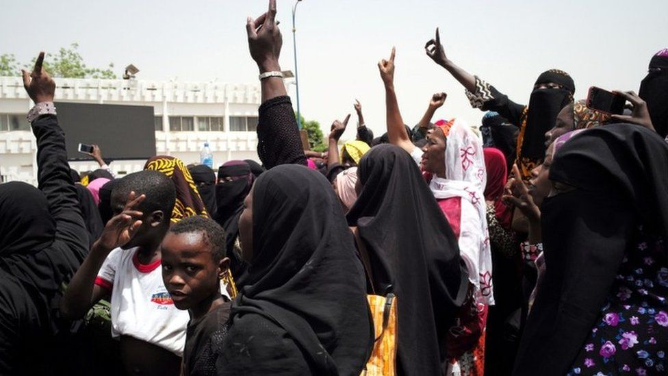 Women at a protest on April 5 gesturing to rally against the government and international forces' failure to tackle rising violence in Mali