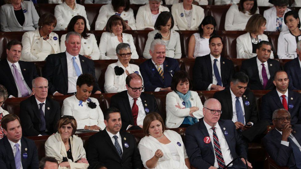 Democrats scowl during Donald Trump's congressional speech.