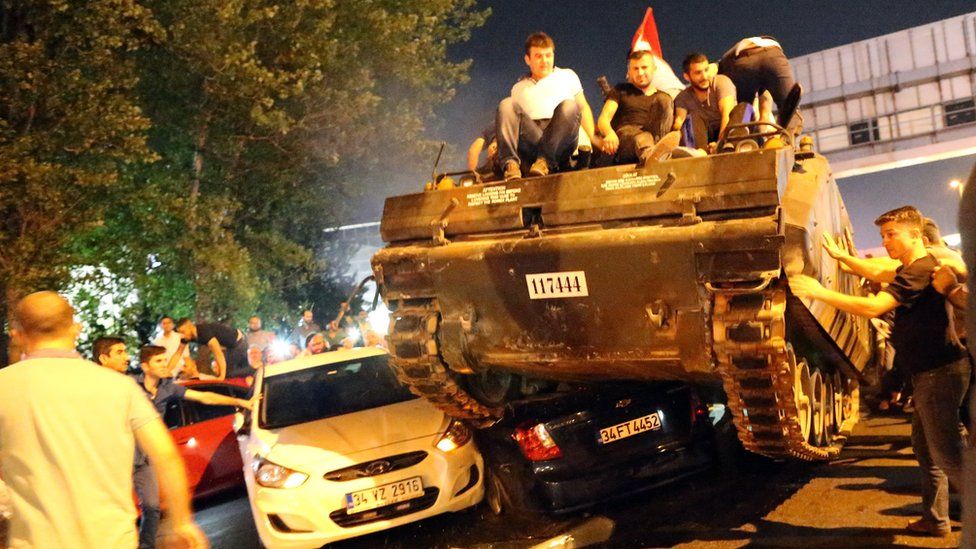 People mount a tank in Turkey on the night of a failed coup