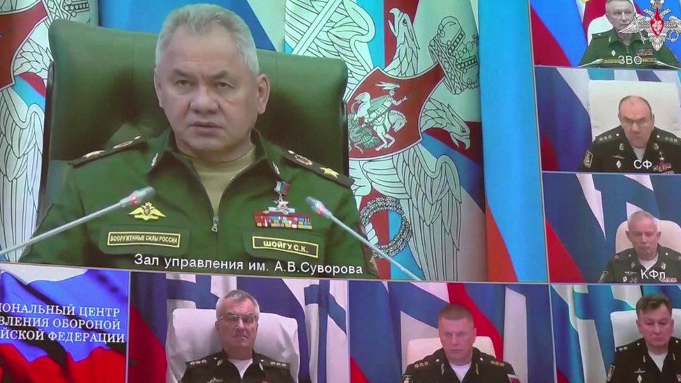 Still from footage shows video link with Defence Minister Sergey Shoygu on big screen and Adm Sokolov immediately below him