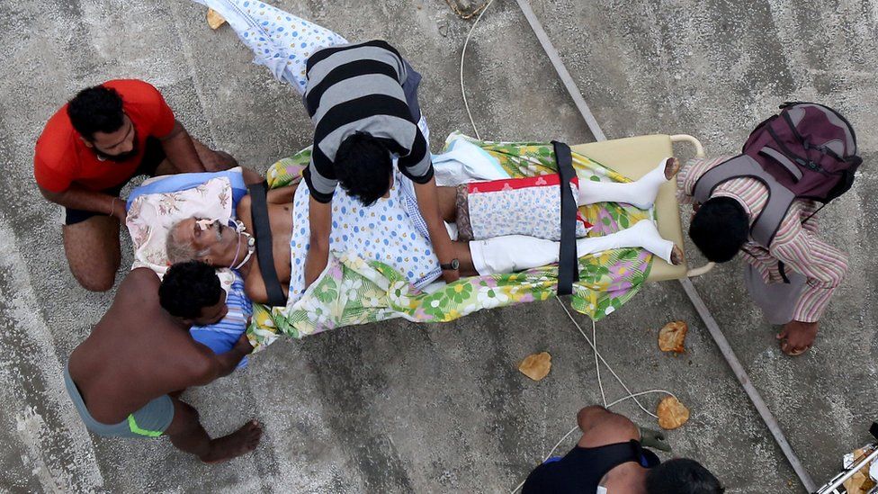 Sick man waits to be evacuated by the Indian Navy