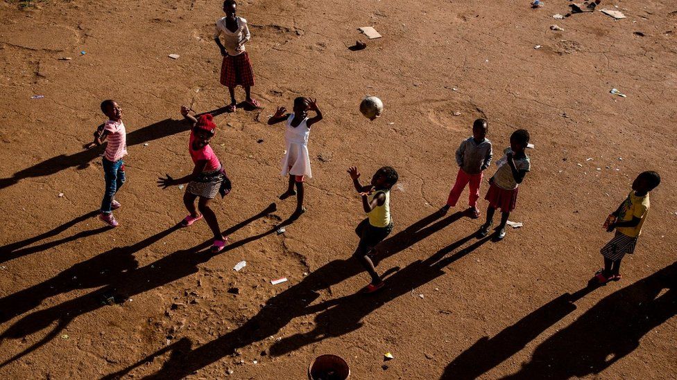 Children play basketball in Harare