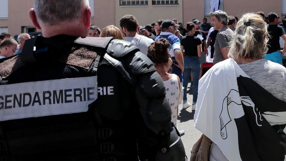 People walk into a housing estate in Corsica after a beach brawl near Sisco (14 August)