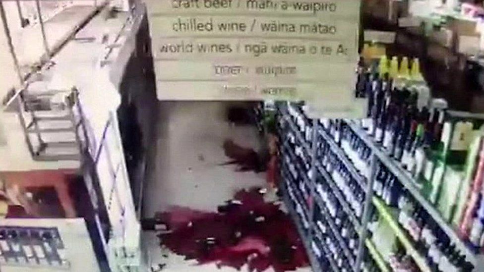 Broken bottles on floor of supermarket