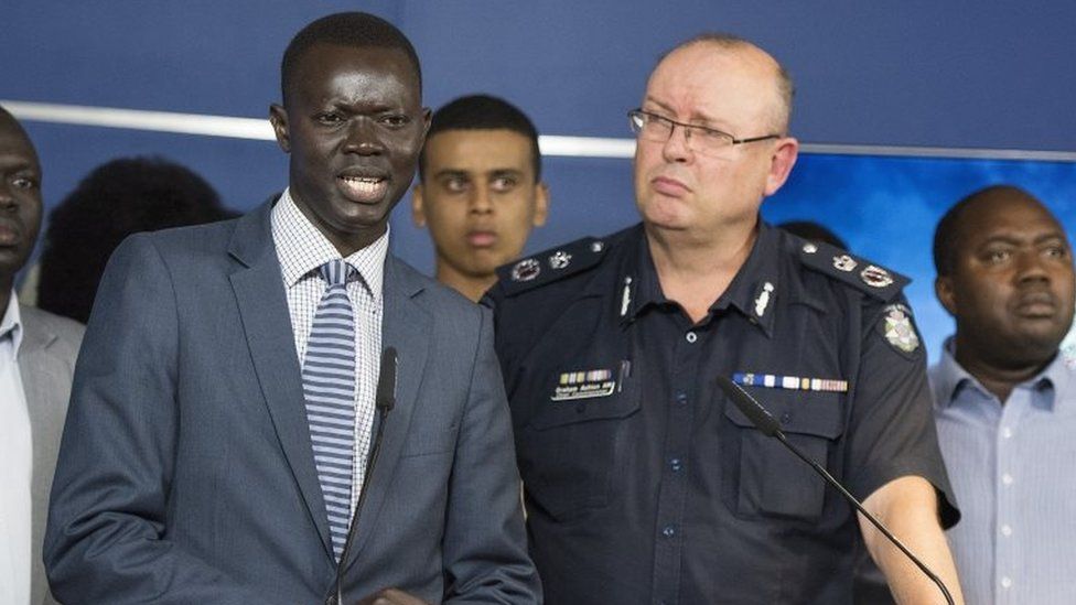 Kot Monoah, a leader in the local South Sudanese community, speaks to the media alongside Victoria's police chief Graham Ashton during a press conference on Wednesday