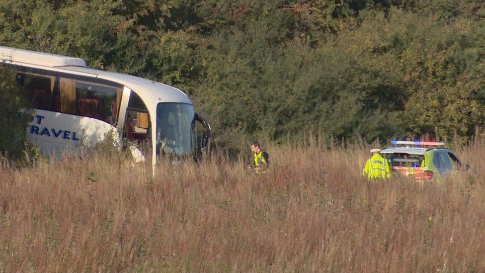 Bus crashes down A1 embankment BBC News