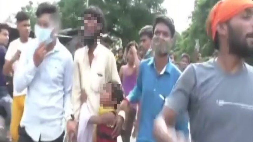 A Muslim man was paraded through the streets as his crying daughter begged the mob to stop hitting him
