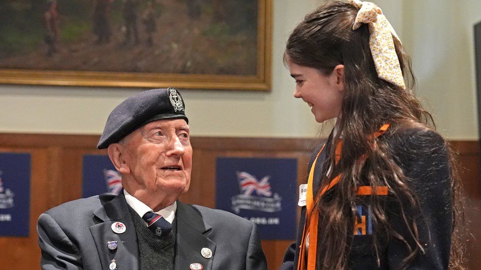 D-Day veteran and Ambassador for the British Normandy Memorial Stan Ford, 98, who served with the Royal Navy, meeting a pupil from Norfolk House School during 'Meet the Veterans: A History Lesson With Those Who Were There'