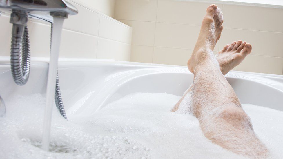 Man's feet in bath