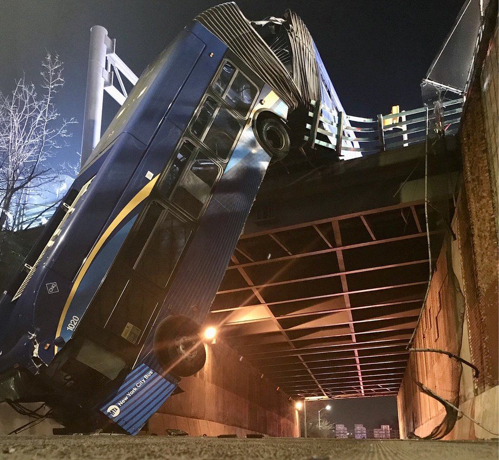 Image from Twitter showing bus hanging from overpass in New York