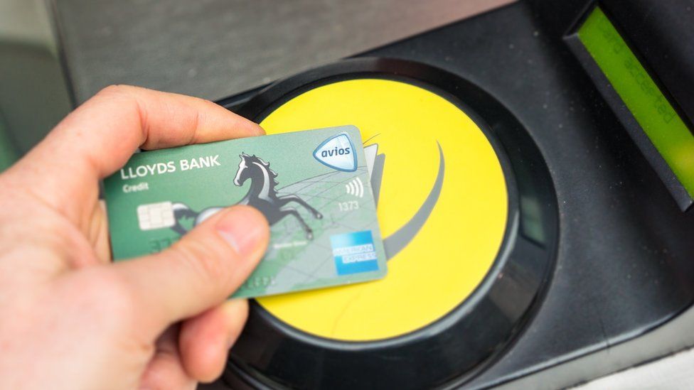 A Lloyds credit card tapped on an Oyster Card reader