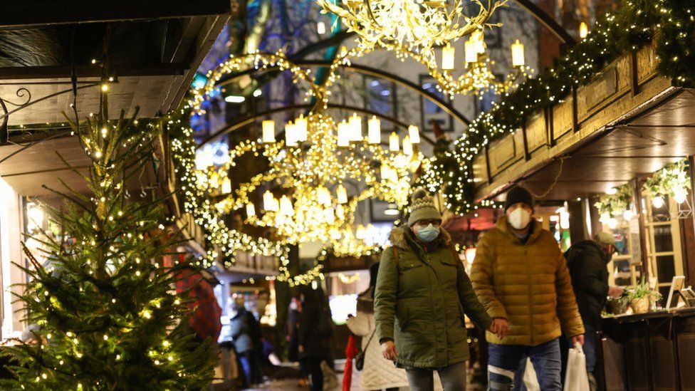 Shoppers wearing face masks at a Christmas market in Cologne