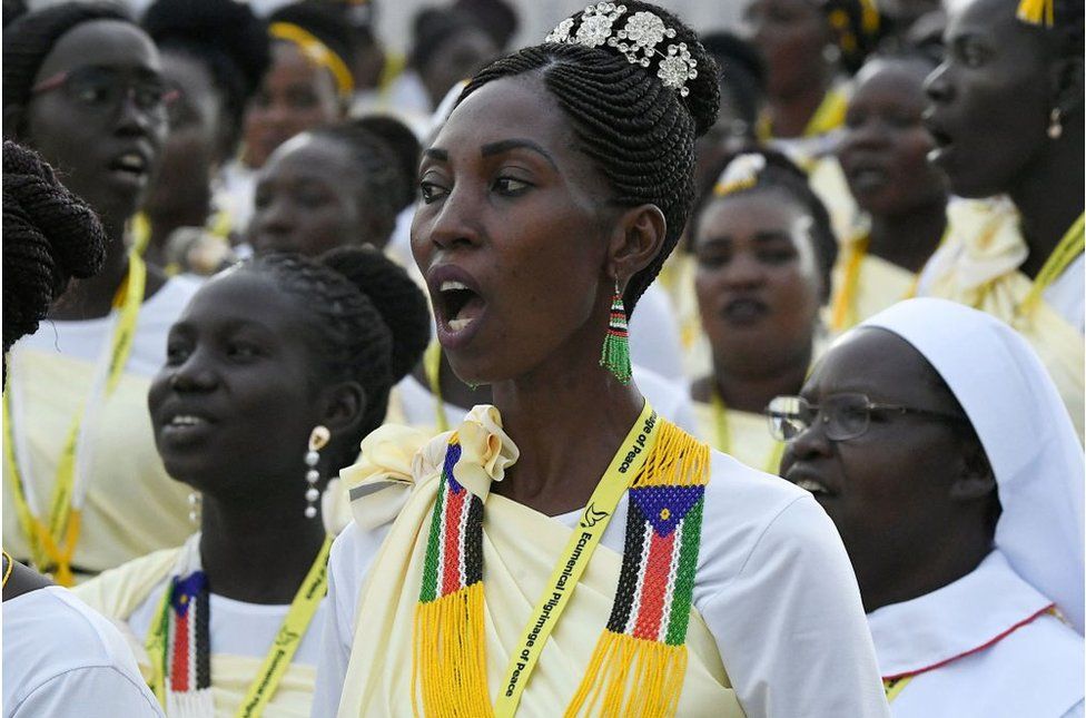 Women who appear to be singing at the Mass