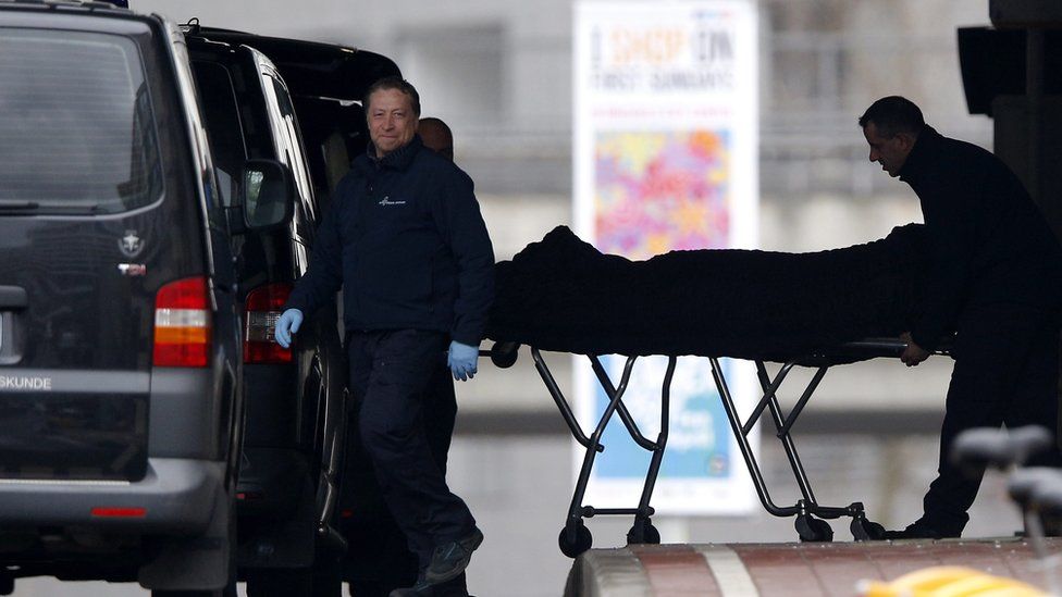 A victim's body is removed from Maelbeek metro station (23 March)
