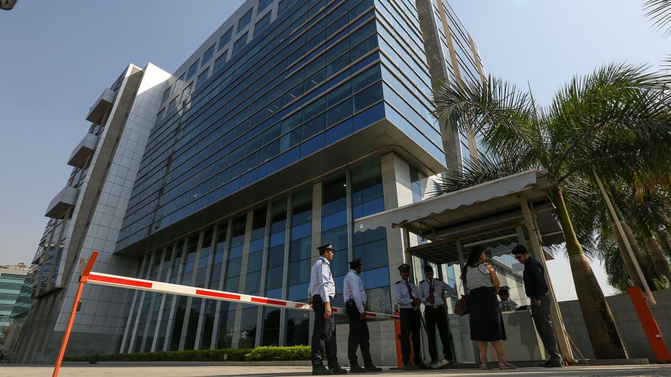 Security personnel stand guard outside the BBC's office in Mumbai