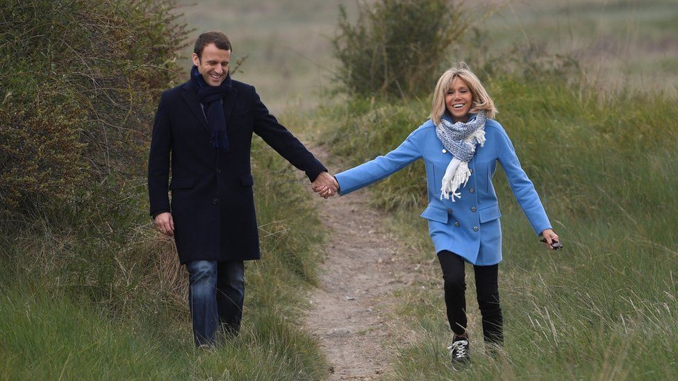 Emmanuel and Brigitte Macron posing for photographs during the presidential campaign