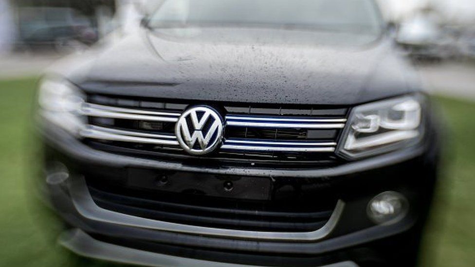 The logo of German car maker Volkswagen is pictured onto a car at a sales branch and garage in Dunkirk