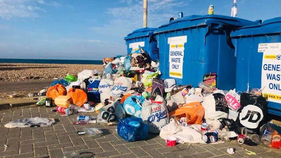 Overflowing bins on Brighton beach