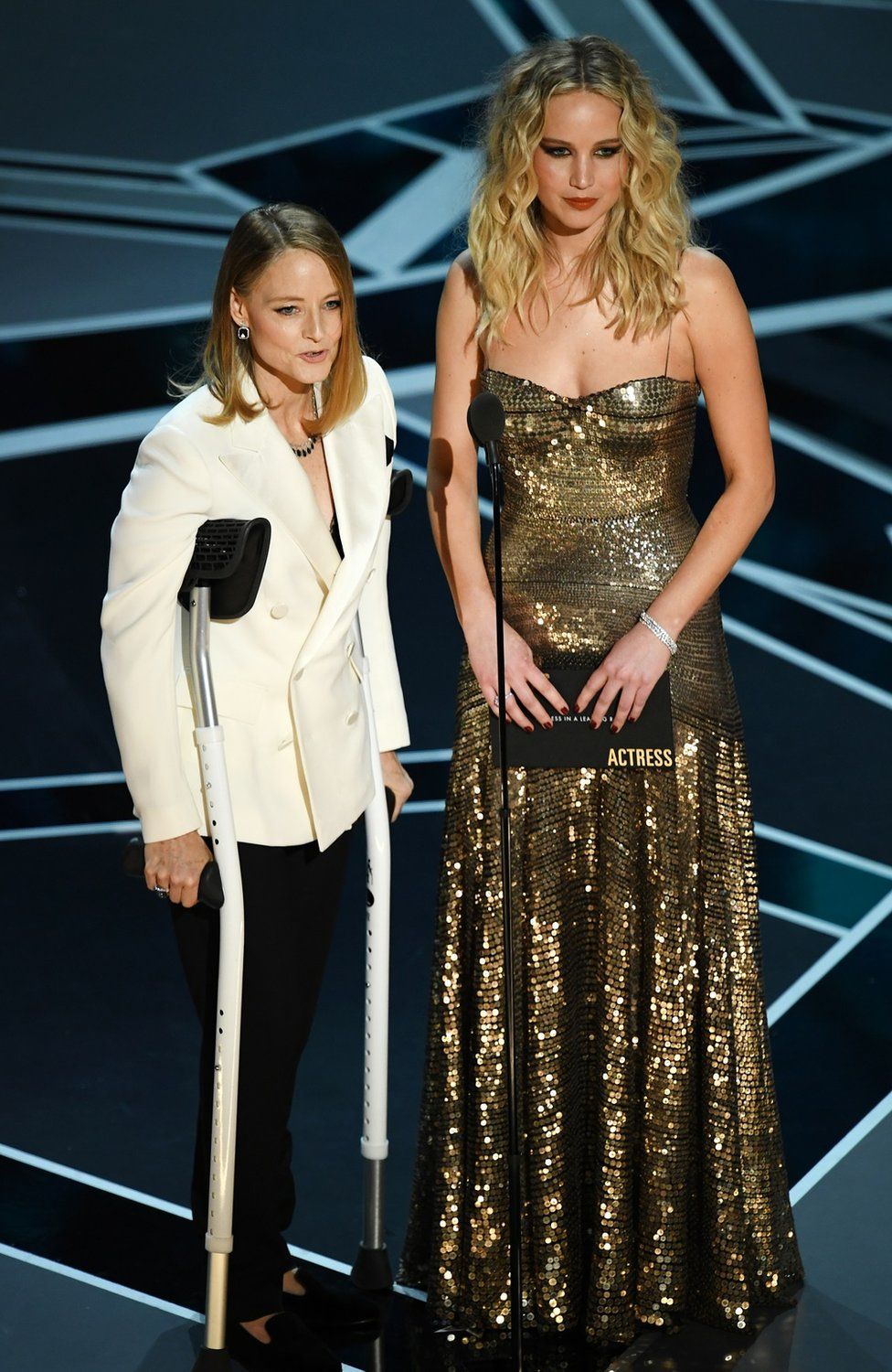 Jodie Foster with crutches and Jennifer Lawrence