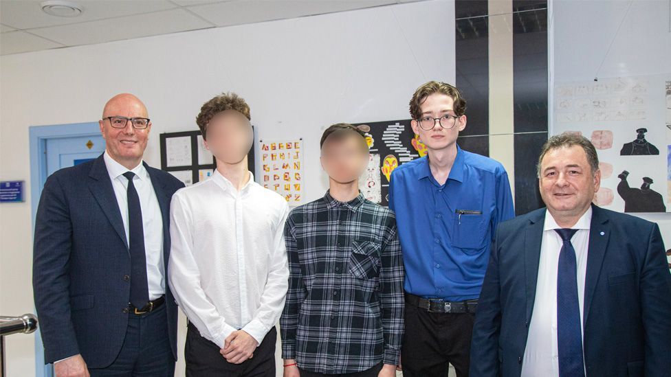 Deputy Prime Minister Dmitry Chernyshenko (left) standing in a line with students including Kevin Lik