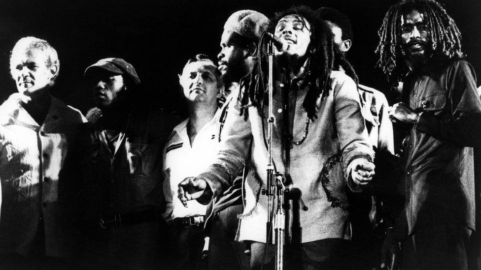 Bob Marley on stage with several others, including Jamaican Prime Minister Michael Manley