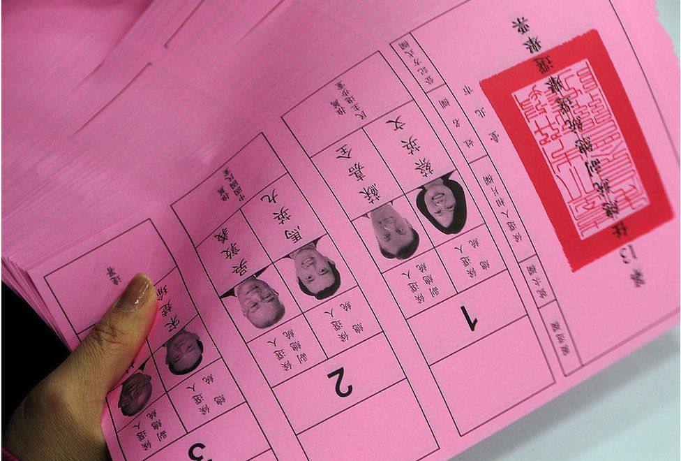 An election official staff counts the presidential elections' ballots at the Taipei City Election Commission on 13 January 2012.