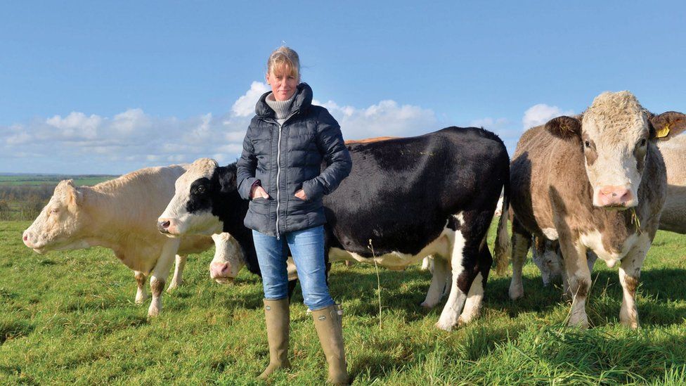 Picture of NFU President Minette Batters stood in a field in front of lots of cows