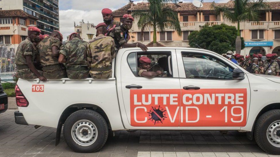 Soldiers in a pick-up truck with the sign saying "Lutte Contre Covid-19" (Fight against Covid-19) in Antananarivo, Madagascar - April 2020