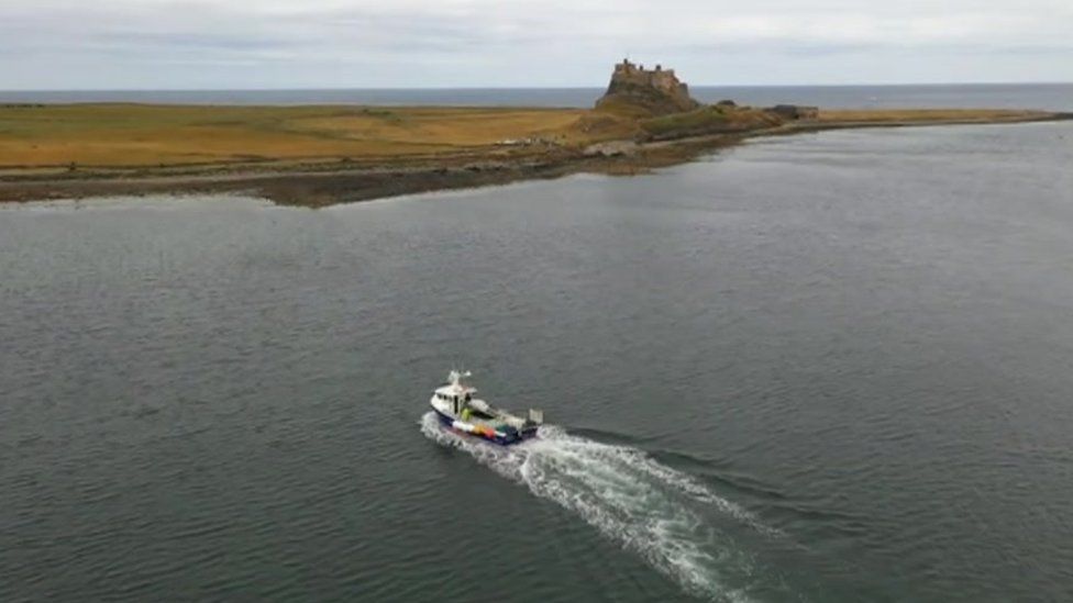 Fishing boat with Holy Island in view