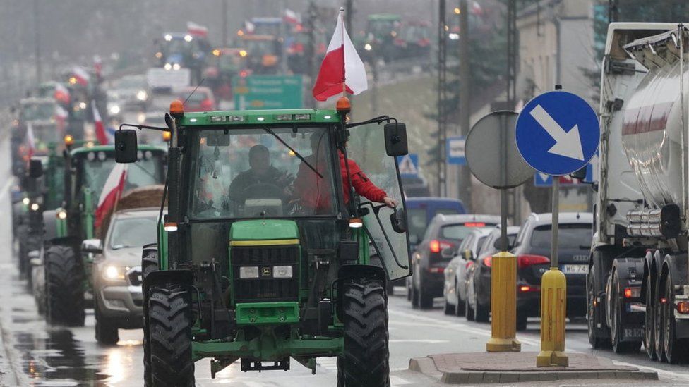 Polish farmers stand with their tractors during a protest against imports of agriculture products from Ukraine as competition from the neighbouring country on January 24, 2024 in Deblin, Poland
