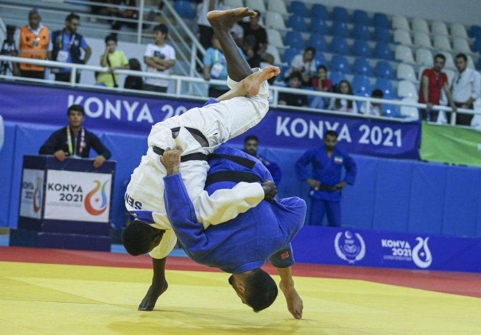 Two men entangled during a judo match.