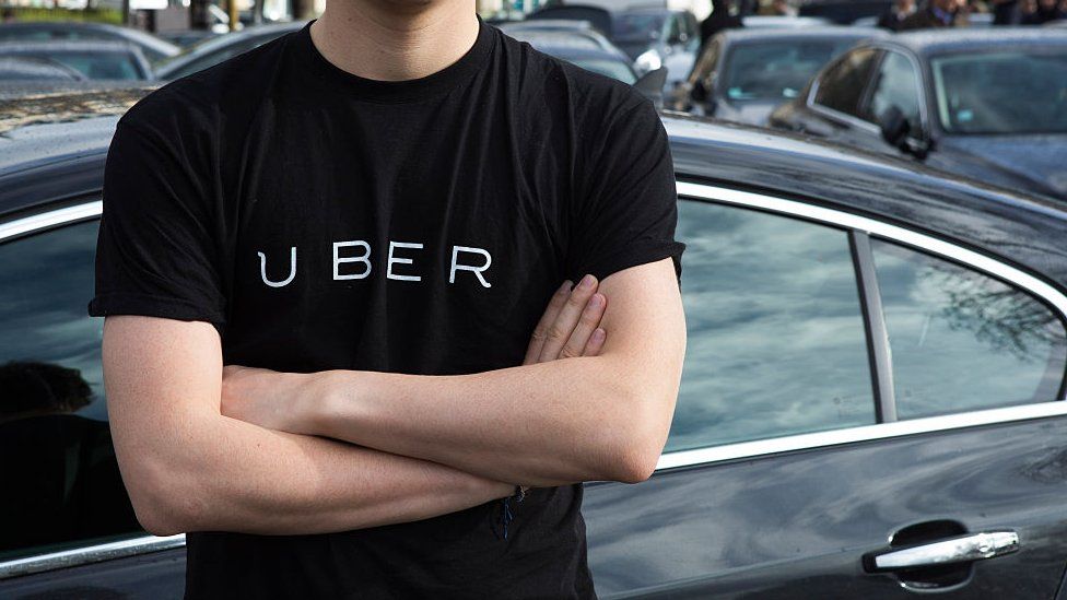 man wearing Uber T shirt with crossed arms