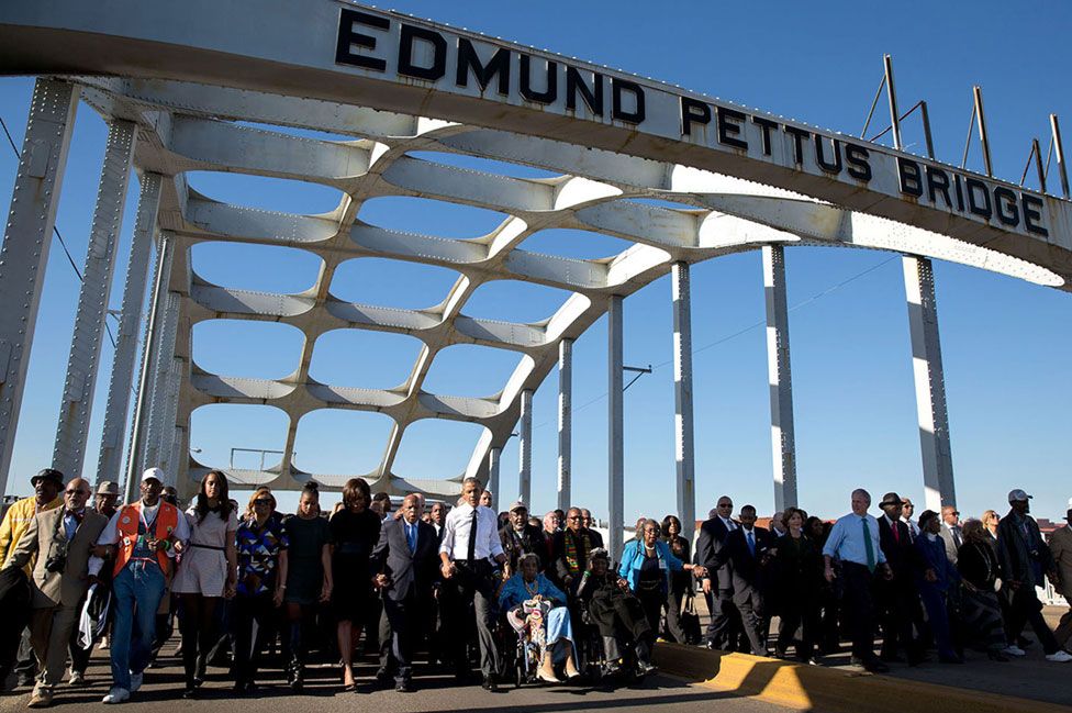 Obama and civil rights hero John Lewis lead a walk across the Edmund Pettus Bridge