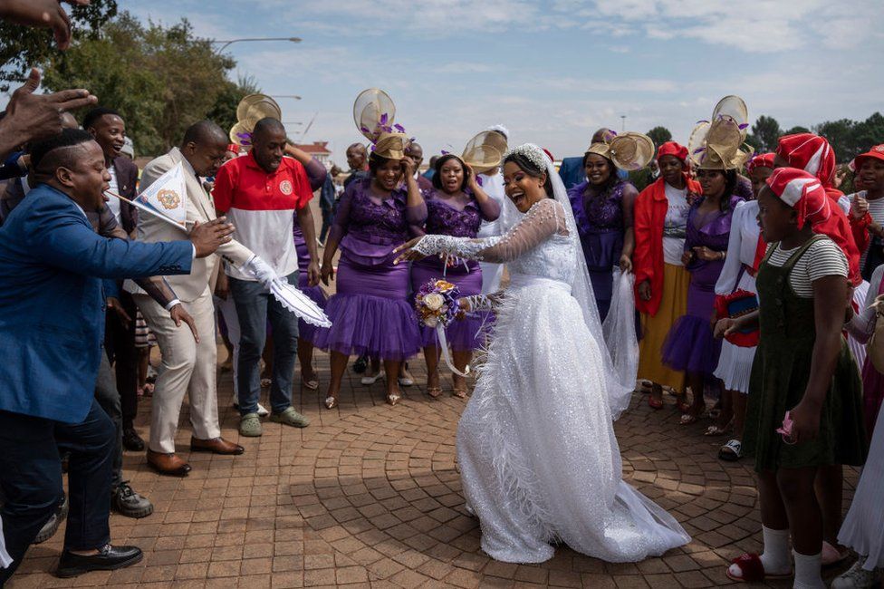 A bride dances as she arrives at the International Pentecostal Holiness Church in Zuurbekom, south of Johannesburg.