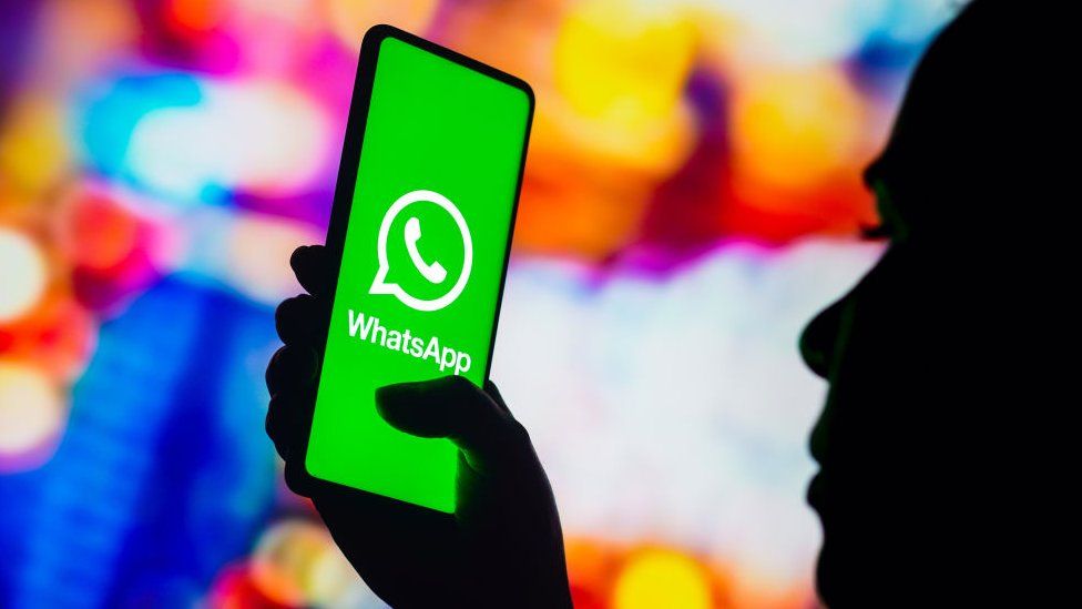An illustration of a phone with a whatsapp logo