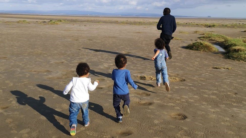 Denis Adide with his three children