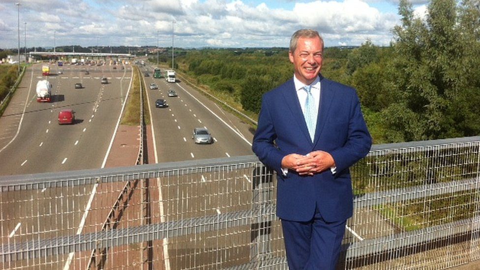 Nigel Farage with the Severn Bridge toll booths in the background