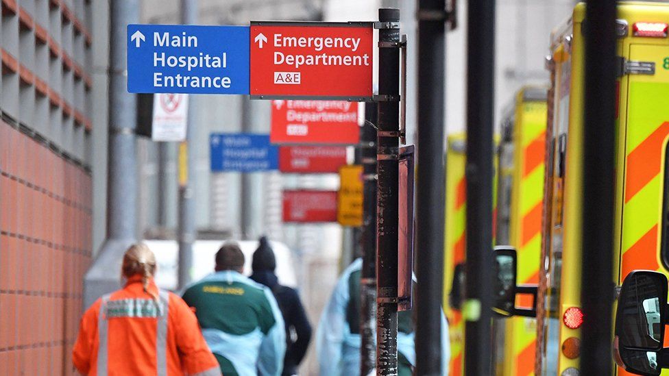 Hospital sign and ambulances on street