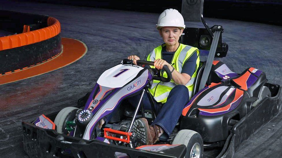 BBC business correspondent Emma Simpson on a go-kart track in a former Debenhams beauty hall