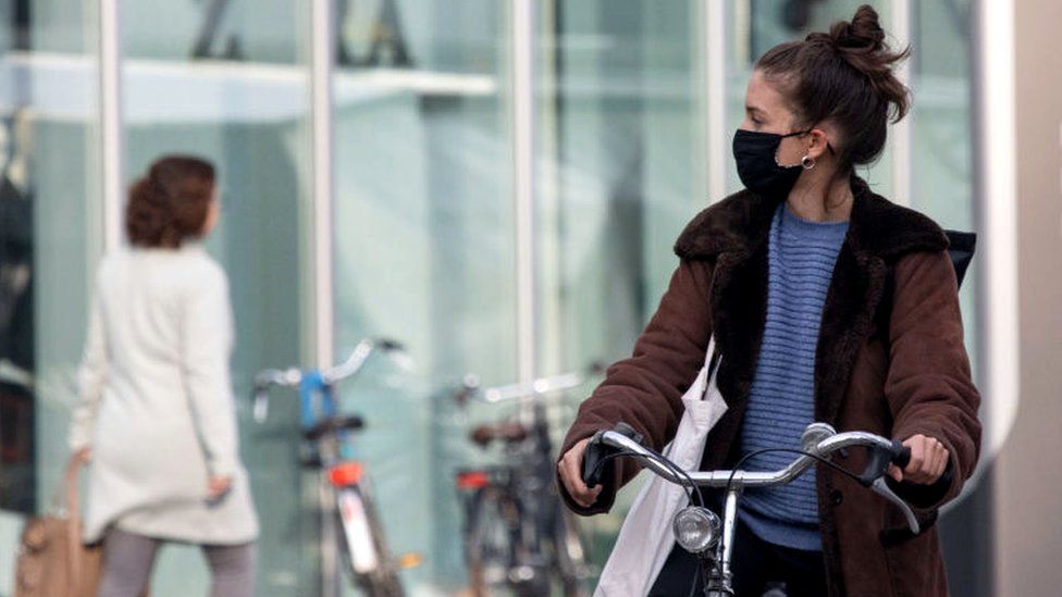 Image shows a woman wearing a face mask in Eindhoven