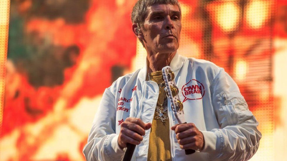Ian Brown performing on stage