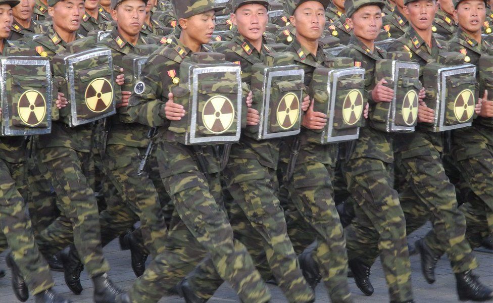 Soldiers carrying a items with the nuclear sign on them during the military parade for the 70th anniversary of the founding Workers' Party, Pyongyang, North Korea - Saturday 10 October 2015