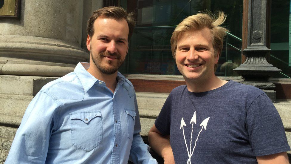 Taavet Hinrikus and Kristo Kaarmann standing outside a bank