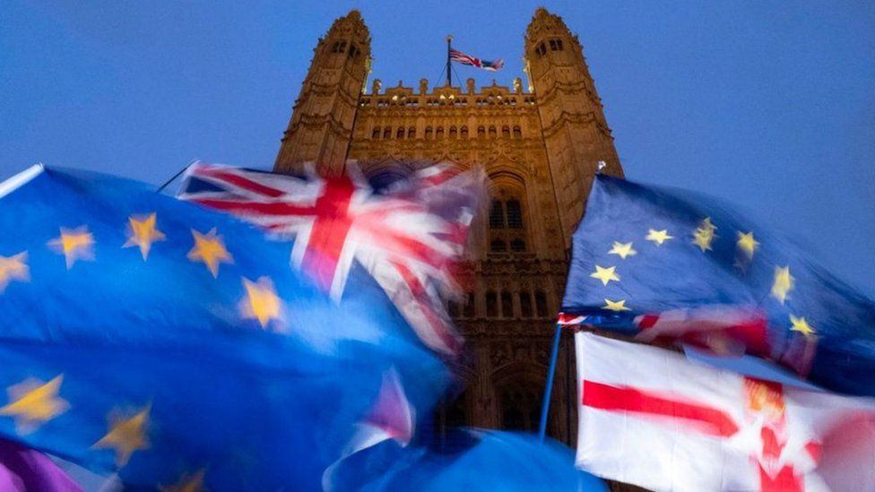 EU and union flags flying outside the Palace of Westminster