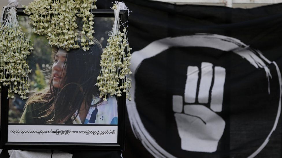 Flowers lay over the image of Mya Thwe Thwe Khaing