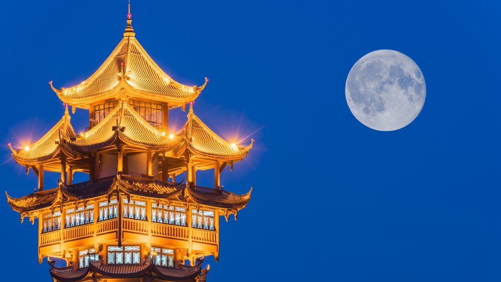 Moon over tower in Chengdu, China