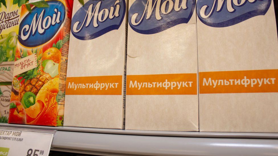 Coloured and white packages are seen on the shelves of a grocery store in Moscow