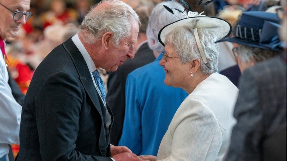 Prince Charles gives the Maundy money during Royal Maundy Service at St George's Chapel